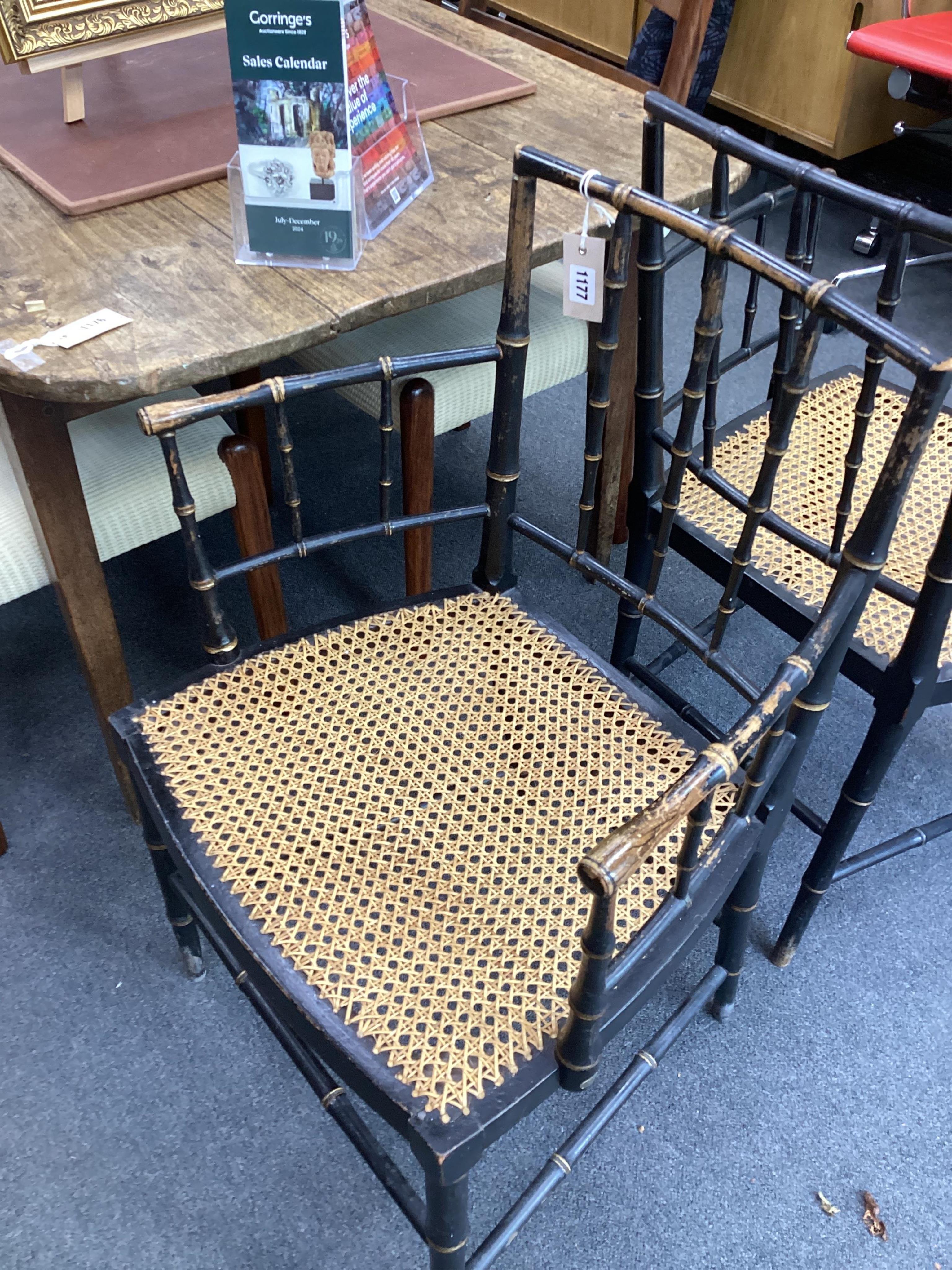 A set of four Regency ebonised simulated bamboo cane seat elbow chairs, width 56cm, depth 43cm, height 86cm. Condition - fair (one stretcher detached but present)